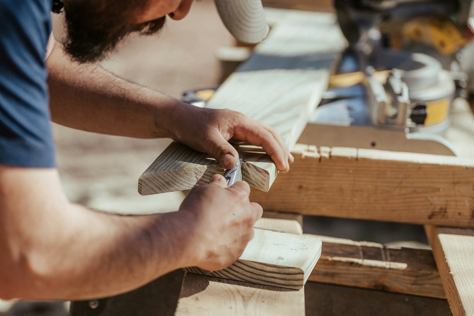 a man working on a piece of wood artisan workers